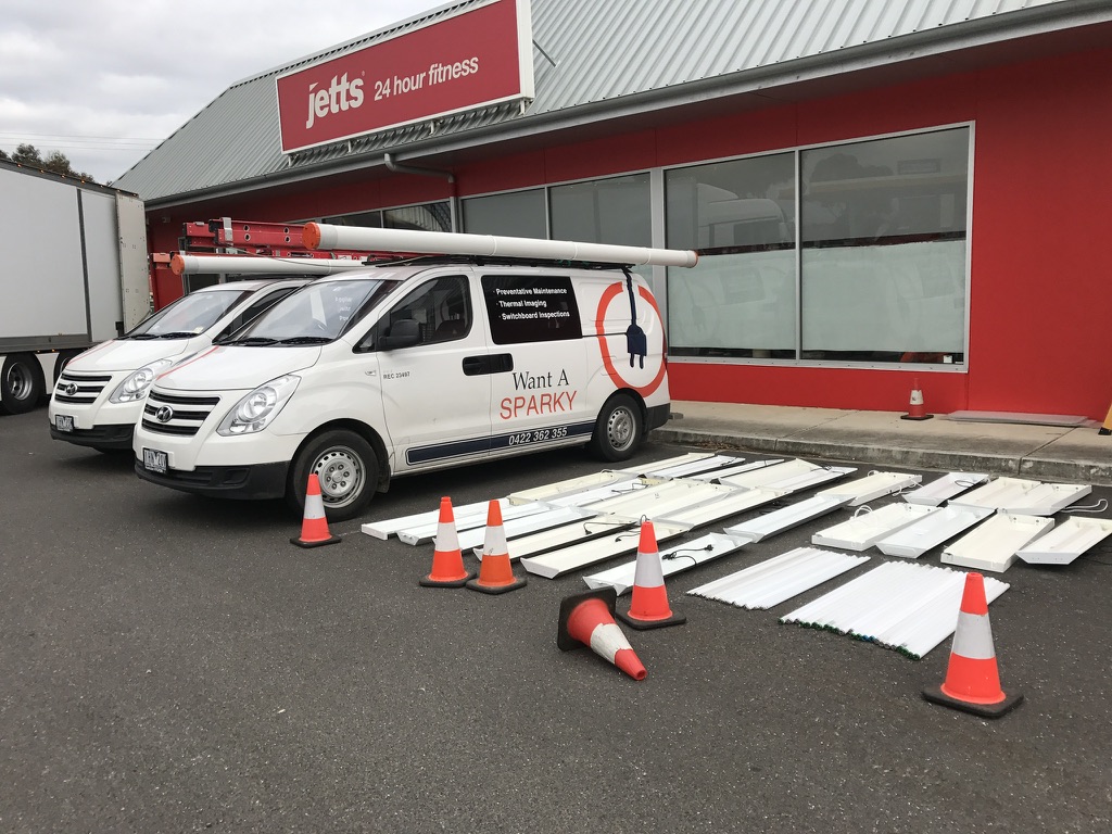 Want A Sparky vehicles during a commercial lighting project