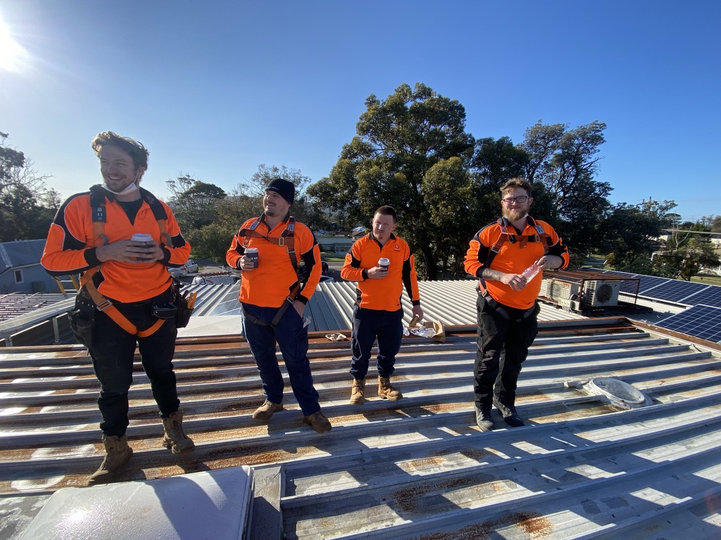 Want A Sparky tradespeople working on a commercial roof